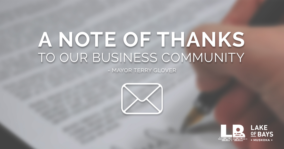 A picture of a blurred out hand signing a document with words over top that say "A note of thanks to our business community"