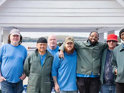 A group photo featuring offenders from the Beaver Creek Institution Community Service Volunteer Group, CO Jeff Earl, and Township of Lake of Bays employee Julie Thur, standing together as they participate in the spring cleanup efforts."