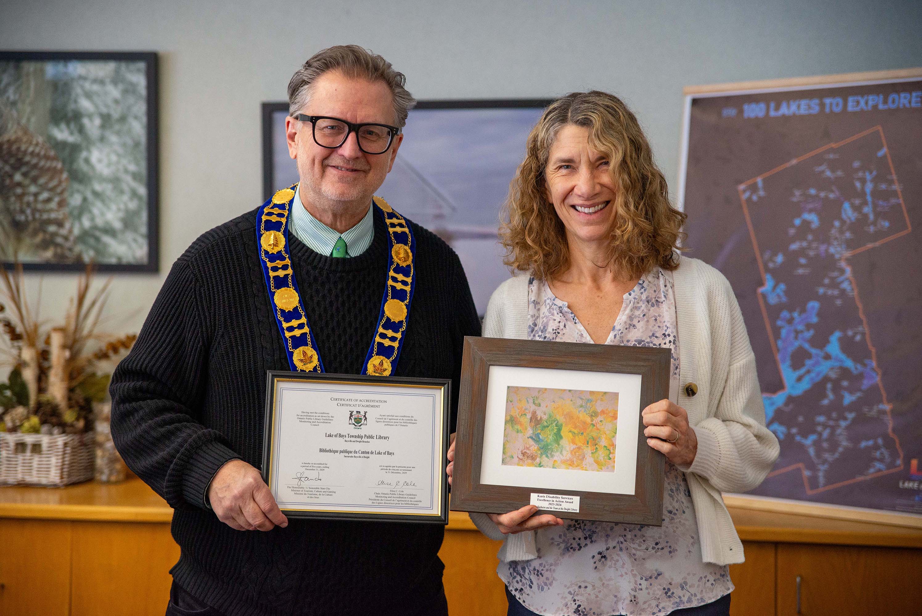 Mayor Glover and Cathy Fairbairn holding the awards.