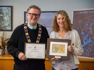 Mayor Glover and Cathy Fairbairn holding the awards.