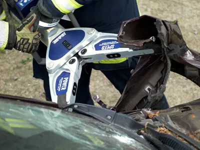 A HURST Jaws of Life SP 555 E3 Spreader being used on a car in a training exercise