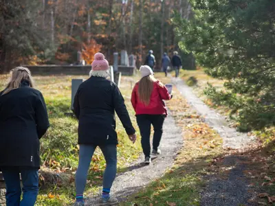 Community members walking the Paint Lake Cemetery Tour