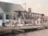 A picture of S.S. Mary Louise (1902) overlayed a current photo of the docks at Dwight Beach