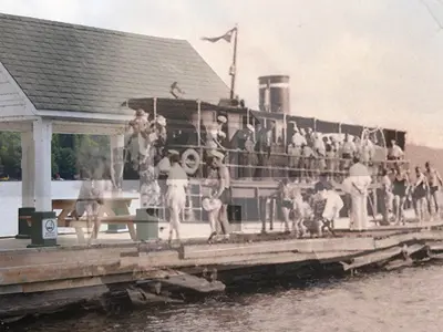 A picture of S.S. Mary Louise (1902) overlayed a current photo of the docks at Dwight Beach