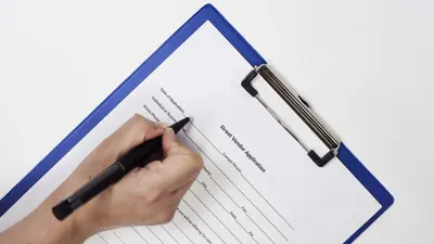 Closeup of a person signing a Street Vendor Application Form