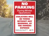 A header image of a snow covered road with a sign that says "No Parking"