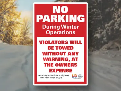 A header image of a snow covered road with a sign that says "No Parking"